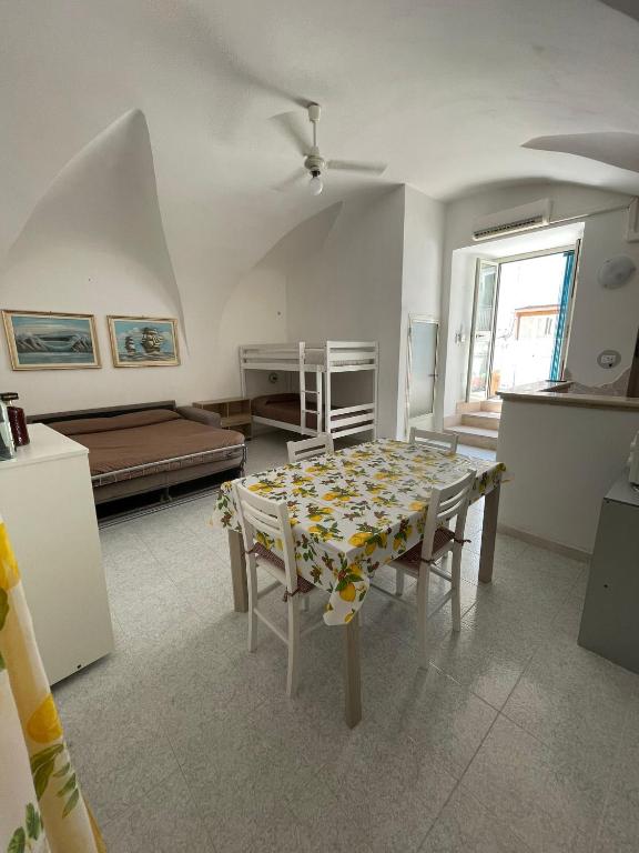 a living room with a table and a bed at Dimora Marina sul Gargano in Vieste