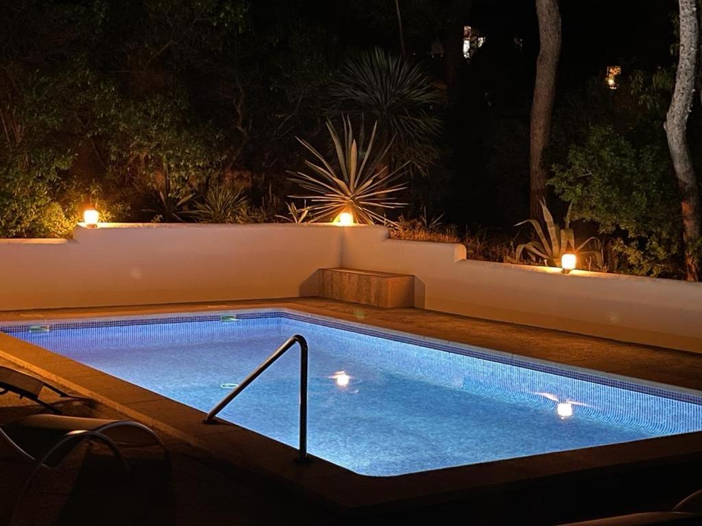 a swimming pool in a backyard at night at Gemütliches Ferienhaus am Club Nautico, Santa Ponça in Santa Ponsa