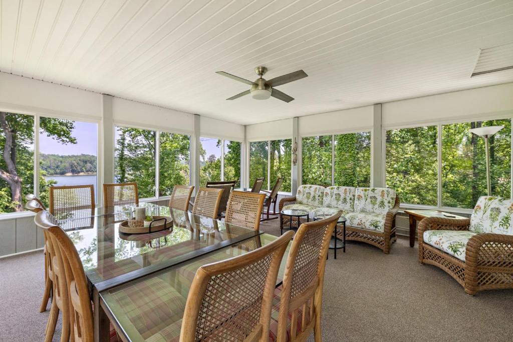 a screened in porch with a glass table and chairs at Heron Hideaway in Wilkesboro