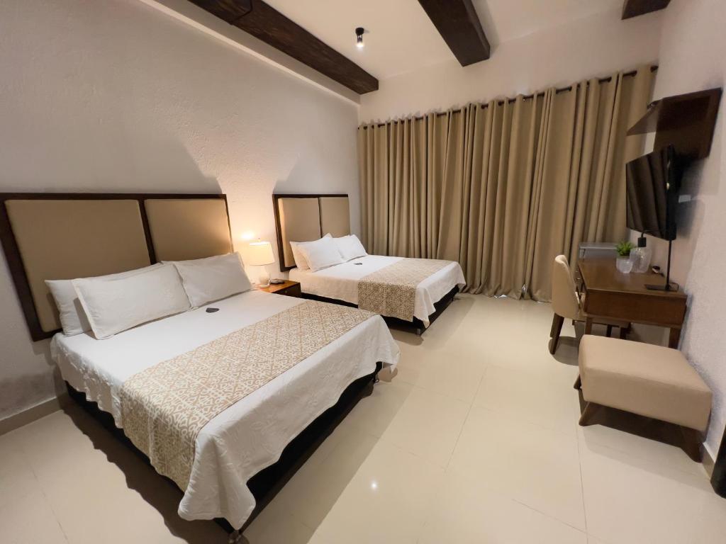 Postel nebo postele na pokoji v ubytování Hotel Dorado Plaza Centro Histórico
