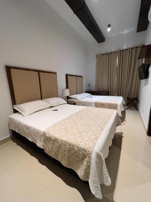 Postel nebo postele na pokoji v ubytování Hotel Dorado Plaza Centro Histórico