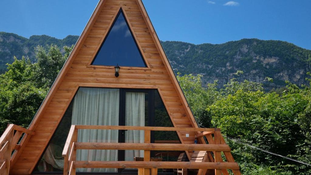 une cabine avec un cadre, une fenêtre et des montagnes en arrière-plan dans l'établissement Cottage Tvishi, à Tvishi