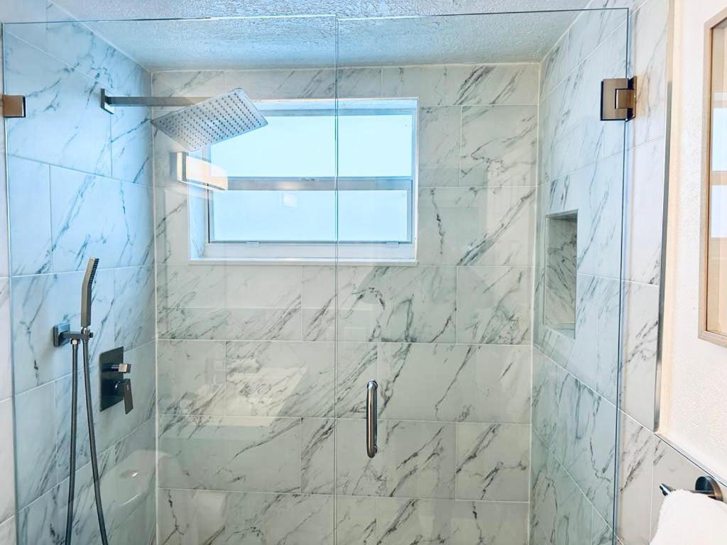 a bathroom with a shower with a window at New Star Suite One in North Miami Beach