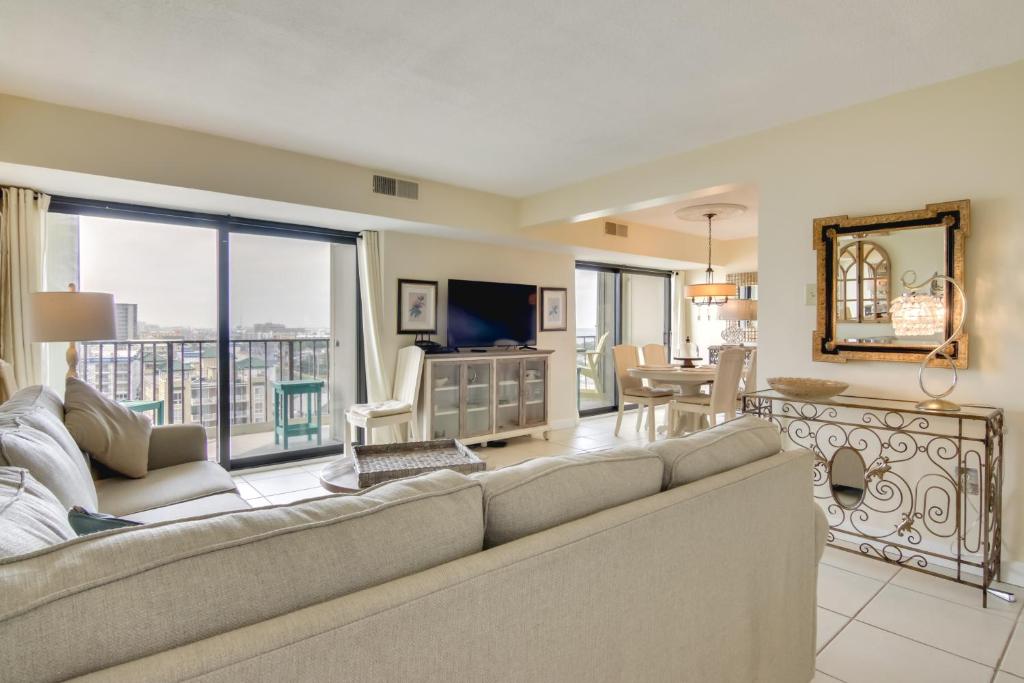 a living room with a couch and a television at Beachfront Ocean City Condo with Pool and Views! in Ocean City