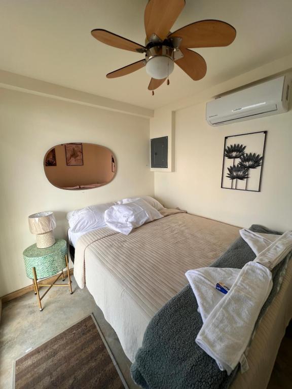 a bedroom with two beds and a ceiling fan at Sunset Hut Hostel in Omoa