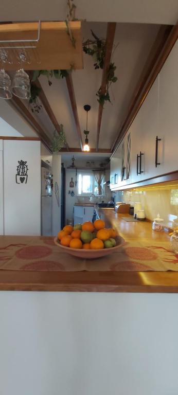 a bowl of oranges on a counter in a kitchen at Havuzlu Bahçeli Müstakil Villa in Side