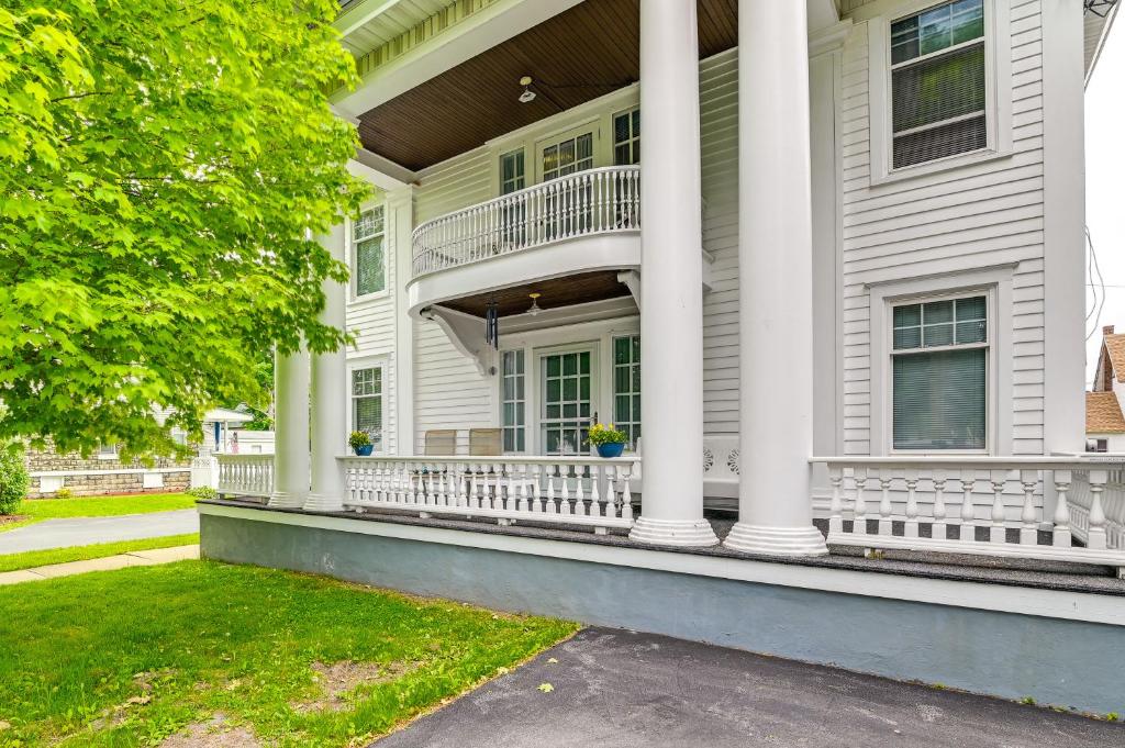a white house with a porch and columns at Cozy Mohawk Getaway Near Herkimer Diamond Mines 