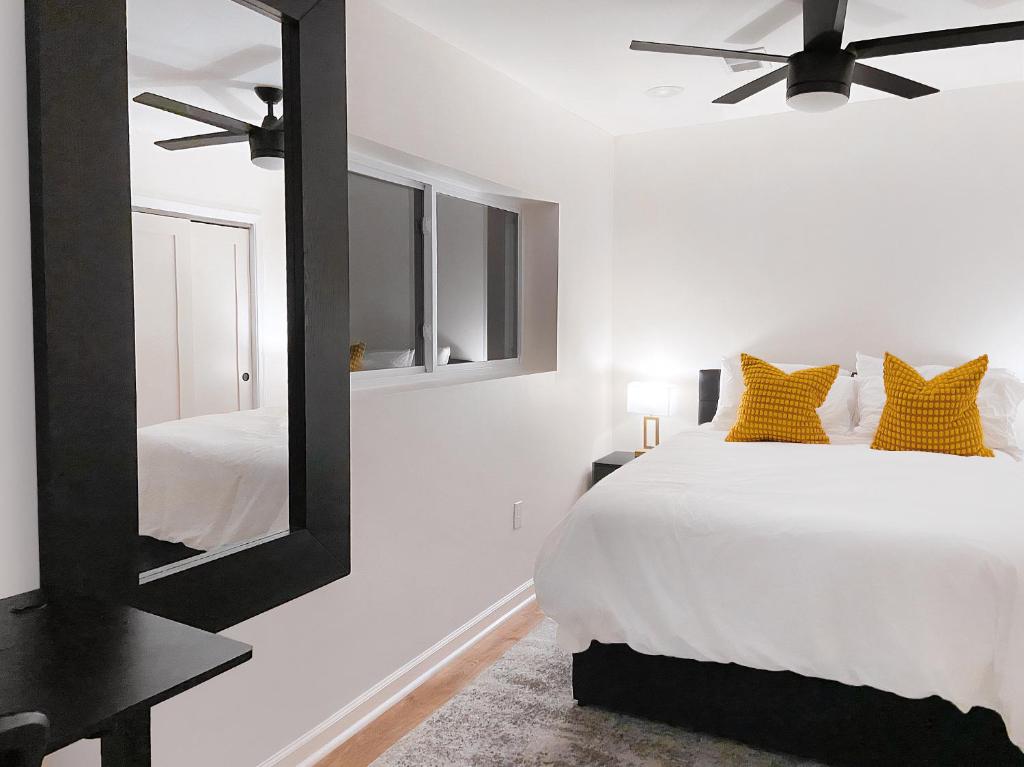 a bedroom with a white bed and a mirror at Rivera Properties in Washington, D.C.