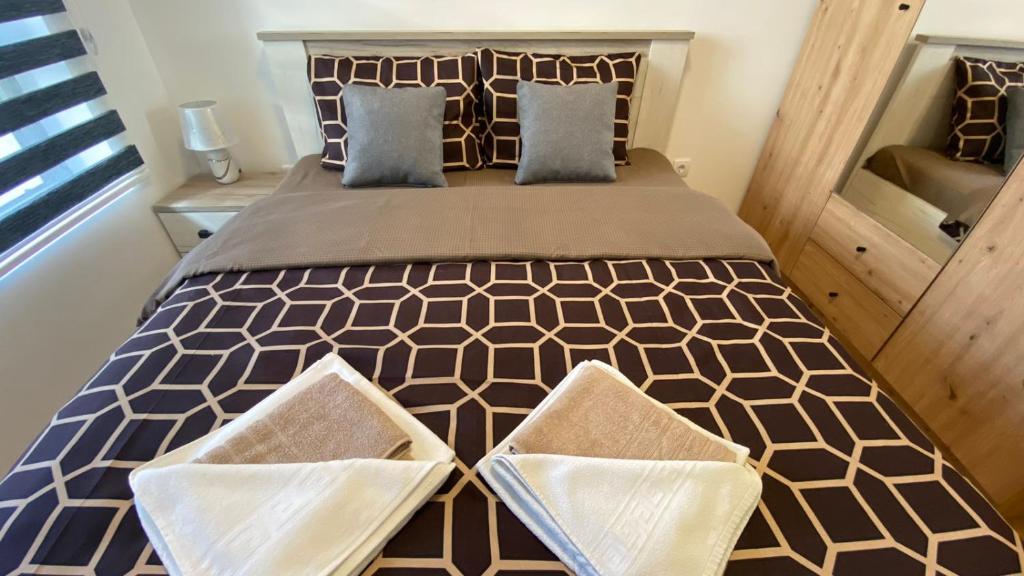 a bedroom with a large bed with two pillows at Apartman Ružica Sokobanja in Soko Banja