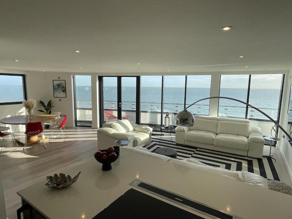 a living room with a view of the ocean at Royal Sands Ramsgate - direct beach access in Ramsgate