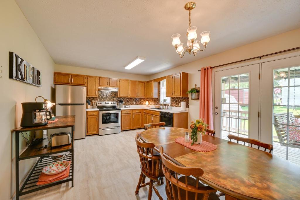a kitchen with a wooden table and a dining room at Quiet Somerset Retreat - Near Lake Cumberland in Somerset