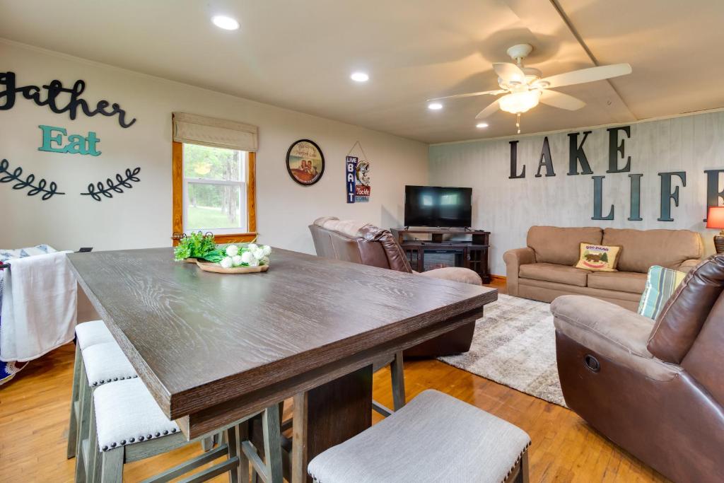 a living room with a table and a couch at Henderson Vacation Rental Less Than 1 Mi to Norfork Lake! in Henderson