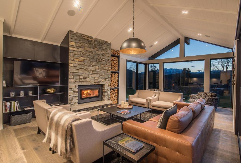 a living room with a couch and a fireplace at Terrace Lodge by Sotheby's Luxury Rental Homes in Queenstown