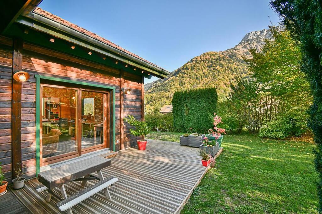 a wooden deck with a bench on a house at ⁂ Chalet Alizée · Nature, lac et montagnes ⁂ in Alex