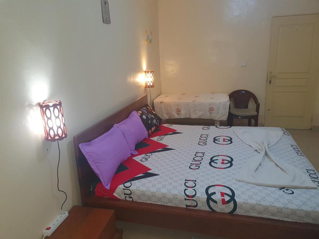 a bedroom with a bed with a sign on it at JADO House in Dakar