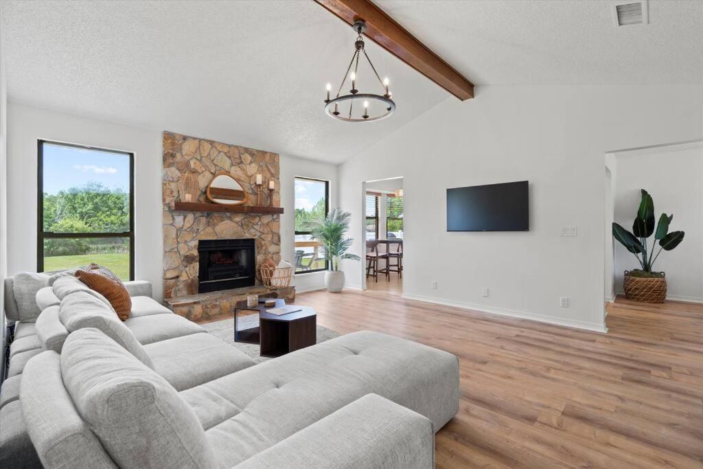 a living room with a couch and a fireplace at Spacious Home Near Beach, Large Yard, Game Room and Dog Friendly in Jacksonville