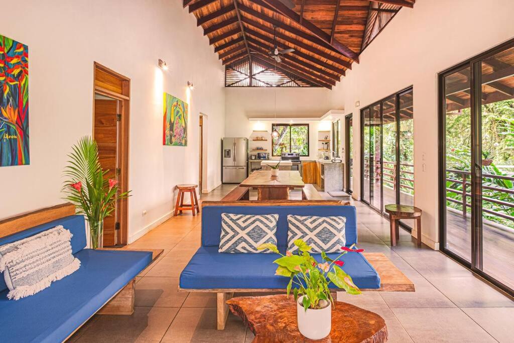 a living room with a blue couch and a table at Villa Ángel (AC/Internet/Pool/Punta Uva beach) in Punta Uva