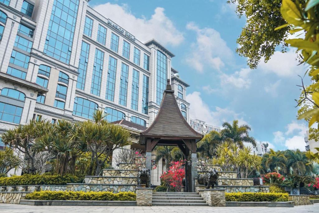 a gazebo in front of a large building at Marco Polo Jin Jiang in Jinjiang