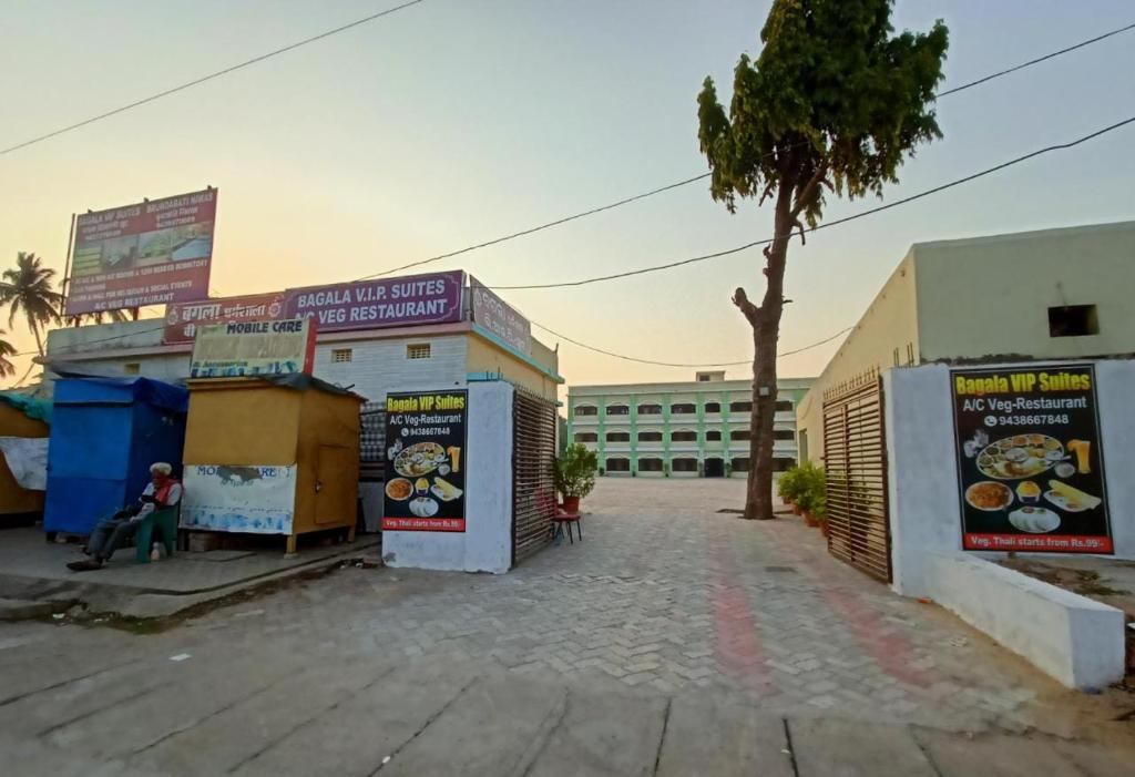 an empty street with a building and a tree at Heritage Bagala VIP Suite in Puri