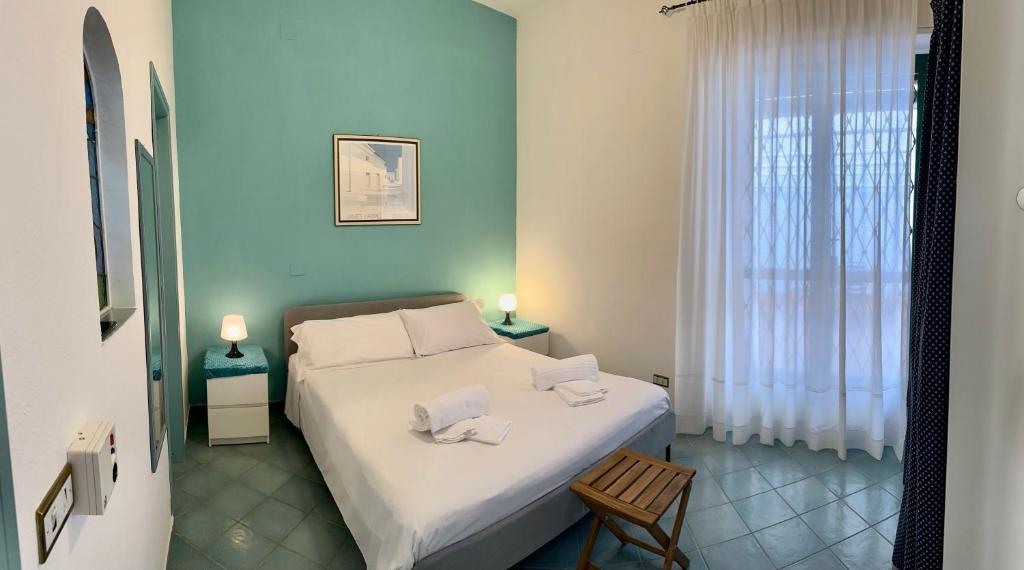 a bedroom with a bed with two towels on it at Villa la caletta in Maiori