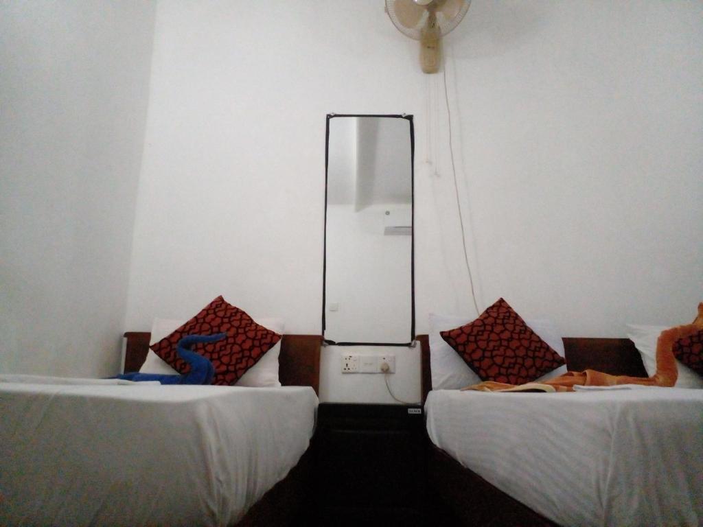 Postel nebo postele na pokoji v ubytování Sigiri Neo Homestay