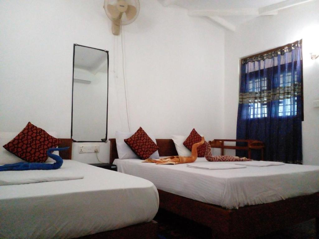 Postel nebo postele na pokoji v ubytování Sigiri Neo Homestay