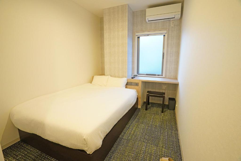 Postel nebo postele na pokoji v ubytování Plaza In Kanku Hotel
