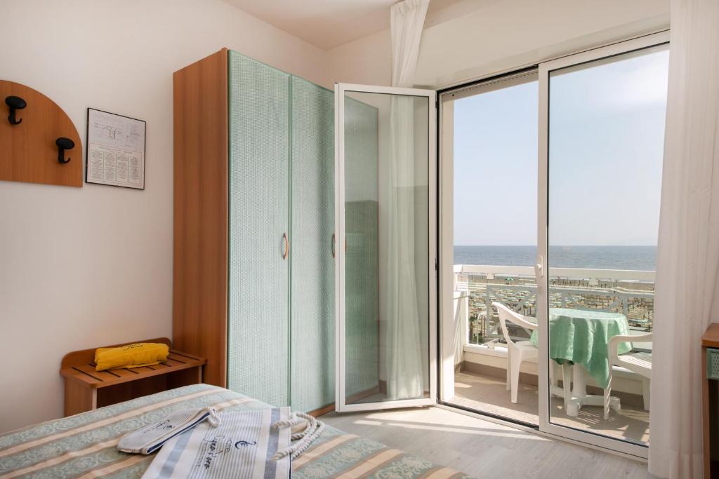 Postel nebo postele na pokoji v ubytování Hotel Cigno D'Oro