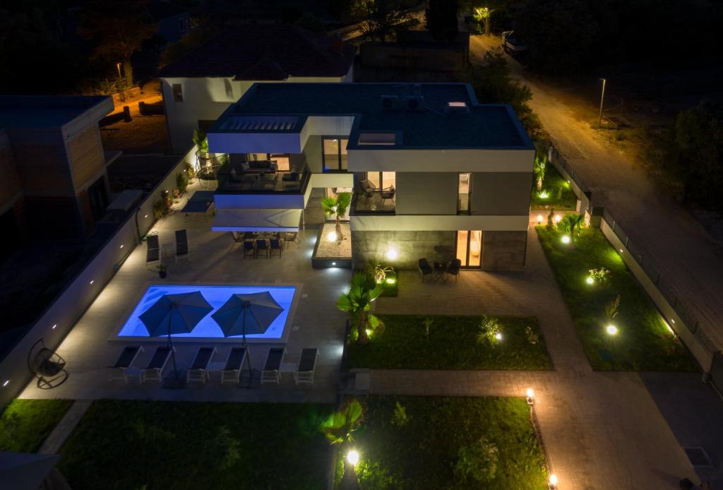 an aerial view of a house at night with lights at Villa N Drage in Nin