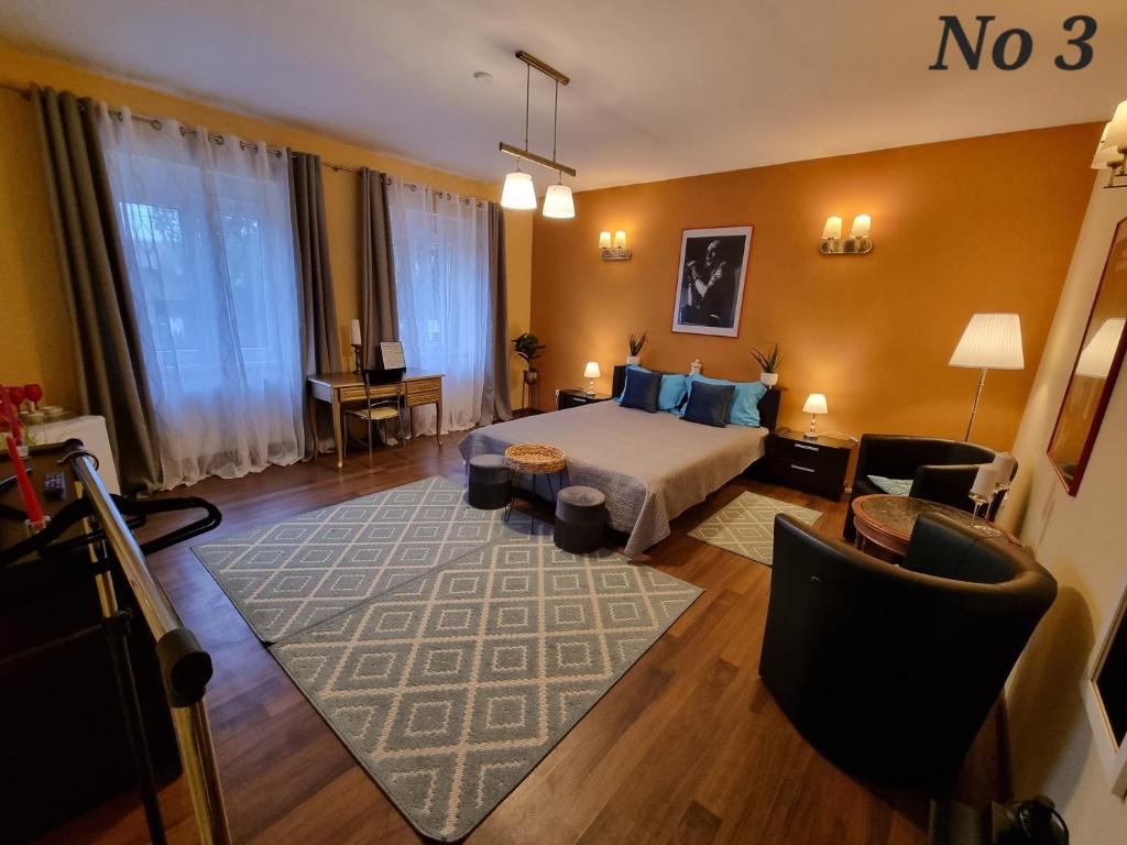 a hotel room with a bed and a living room at Atia Residence in Sibiu