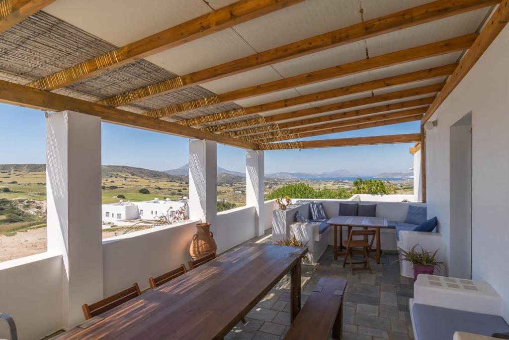 a living room with a wooden bench and a table at Casa Mia Milos in Paleochori