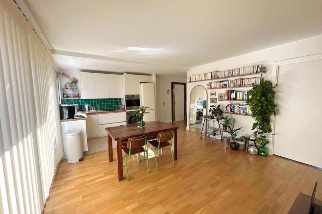 a kitchen and dining room with a table and chairs at Cosy, calm 70m2, 2 bedroom flat. in Paris