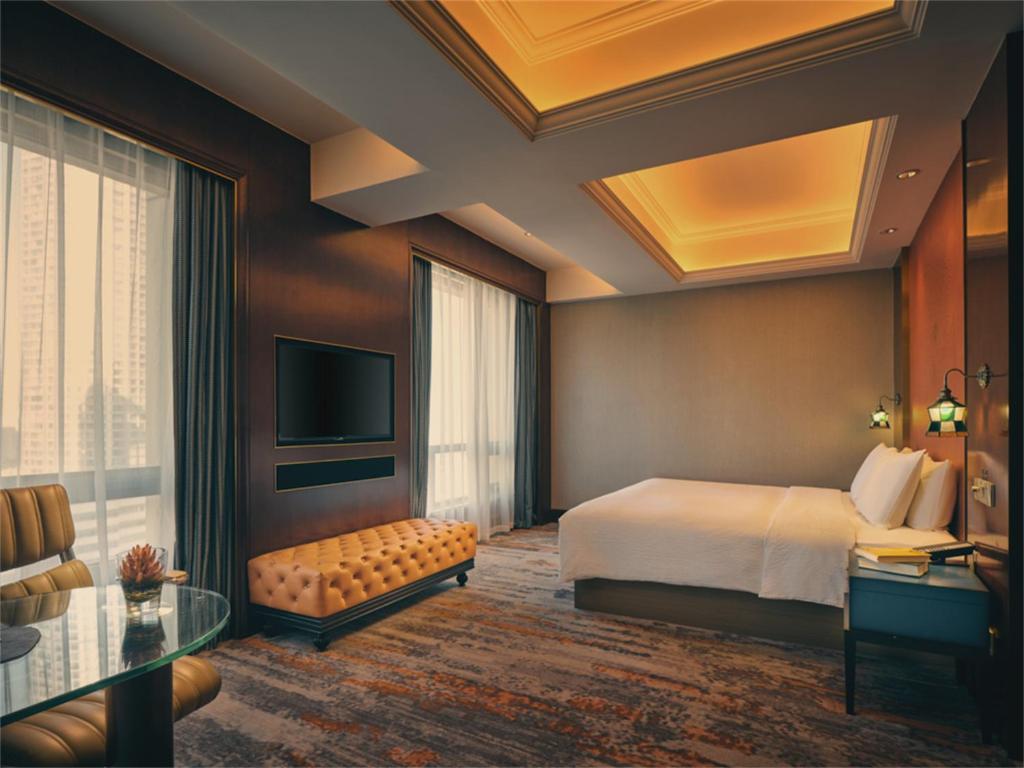 Postel nebo postele na pokoji v ubytování Wanda Yi Hotel Wuxi