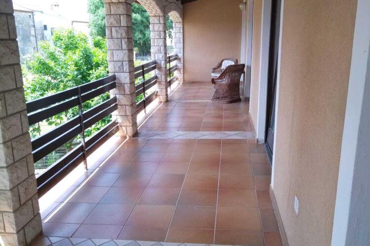 a hallway with a tile floor and a balcony at Spacious Holiday Home in Verteneglio in Brtonigla