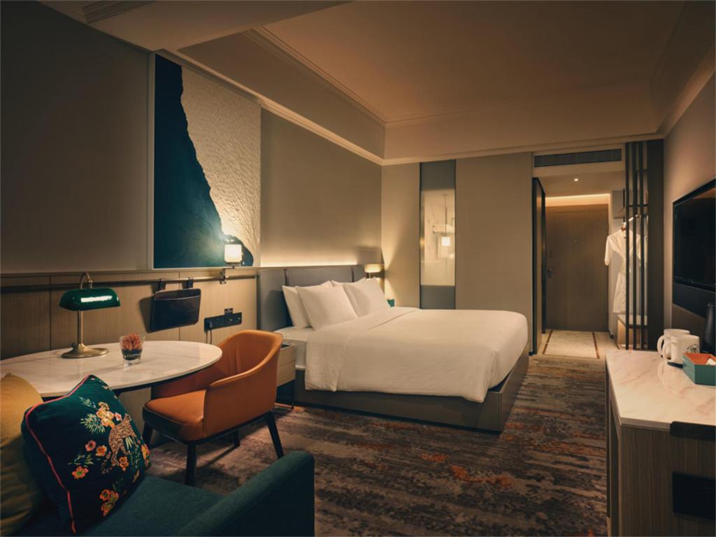 Postel nebo postele na pokoji v ubytování Wanda Yi Hotel Wuxi