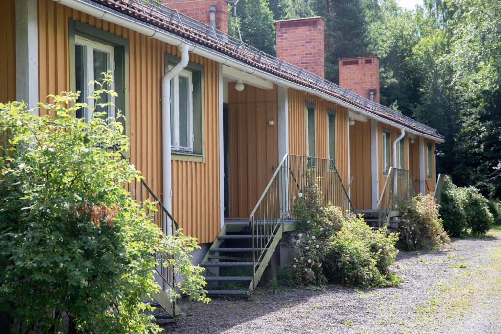 a row of houses with stairs and a porch at Sikfors Gästhus in Hällefors