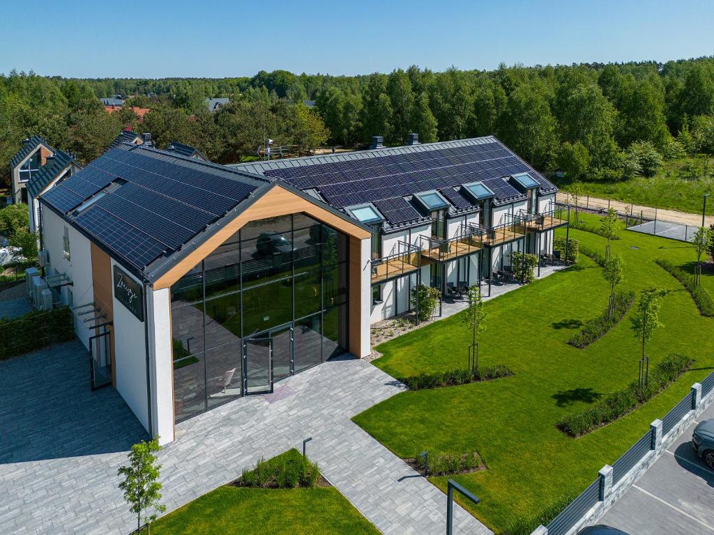 an aerial view of a house with solar panels on it at Zacisze Lubiatowo in Lubiatowo