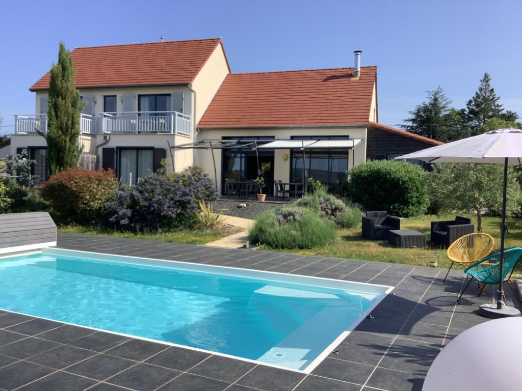 a swimming pool in front of a house at Les Etoiles de Calès in Calès