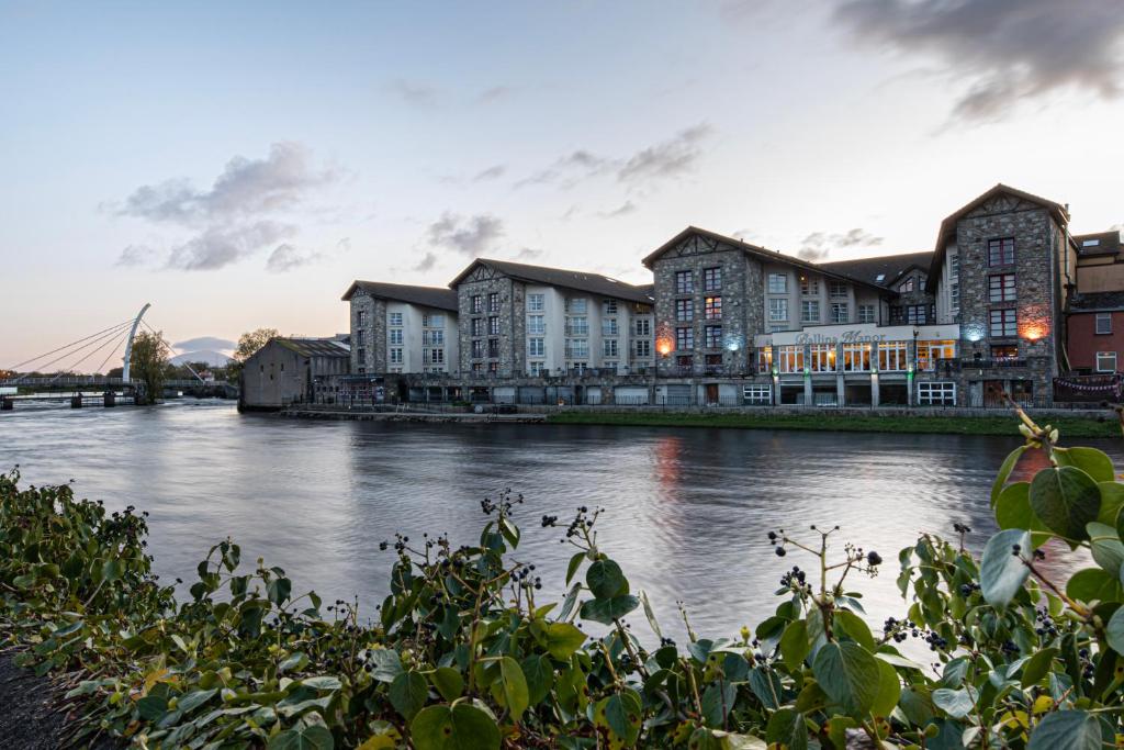 uma vista para um rio com edifícios ao fundo em Ballina Manor Hotel em Ballina