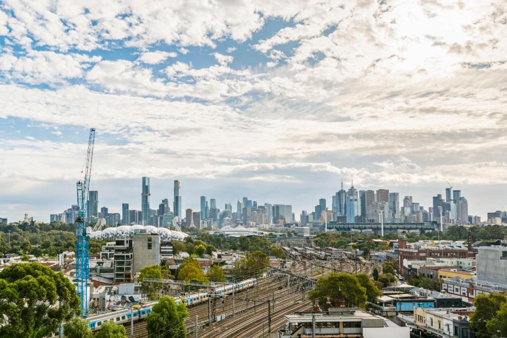 a view of a city skyline with a train at Your Gateway to Sports and Entertainment-00215 in Melbourne