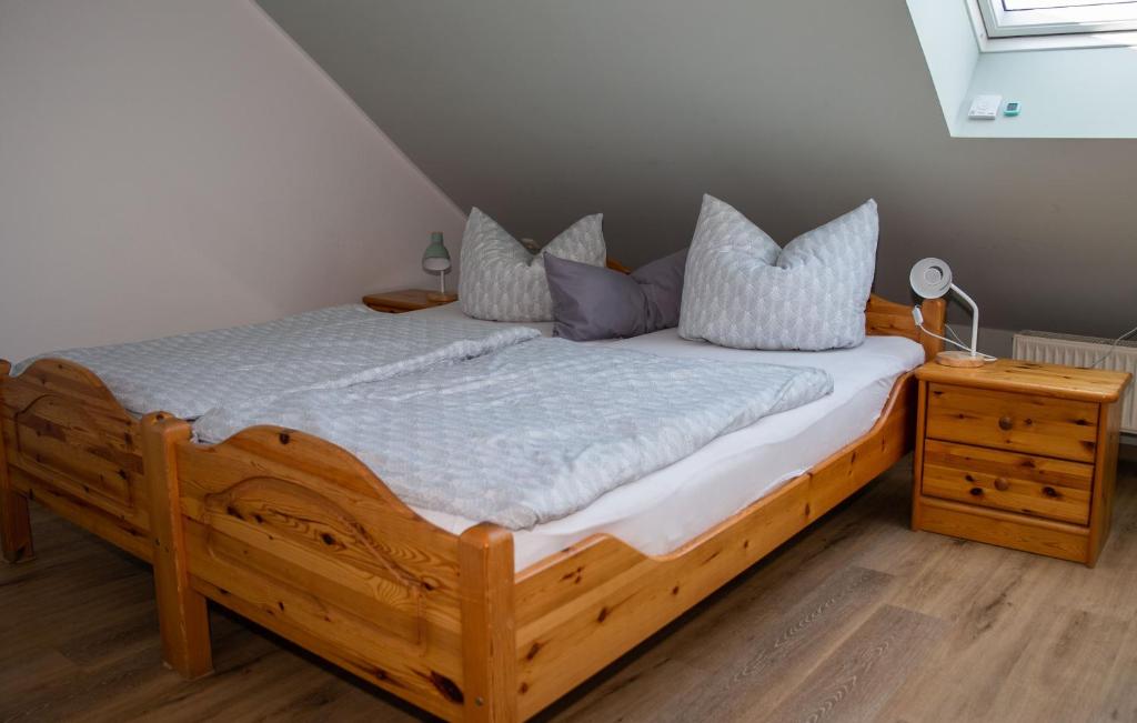 1 dormitorio con cama de madera y almohadas en FeWo Sabine, en Ebern