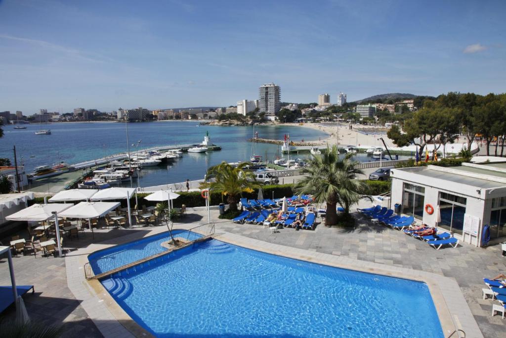 a swimming pool with a view of a marina at Roc Portonova Apartaments in Palmanova