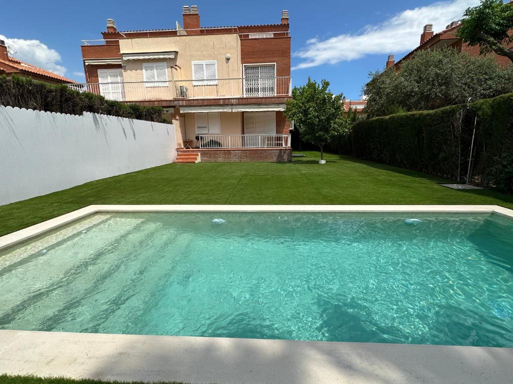 a swimming pool in the yard of a house at Myhost Augusta Altafulla in Altafulla