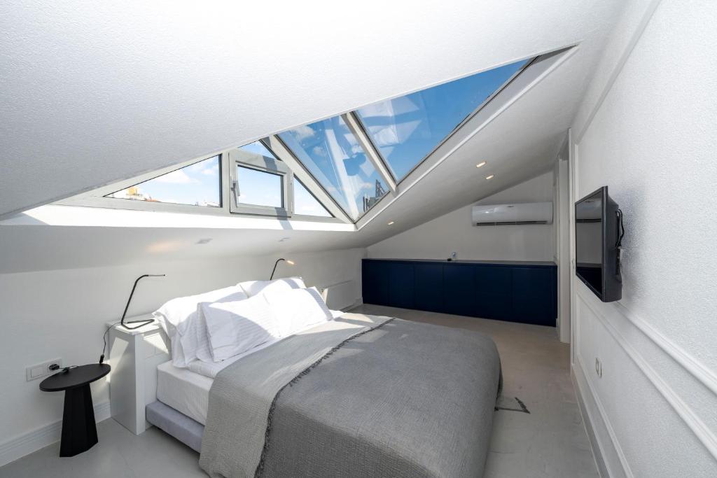 a bedroom with a bed with a large skylight at Juno Hotel Taksim in Istanbul