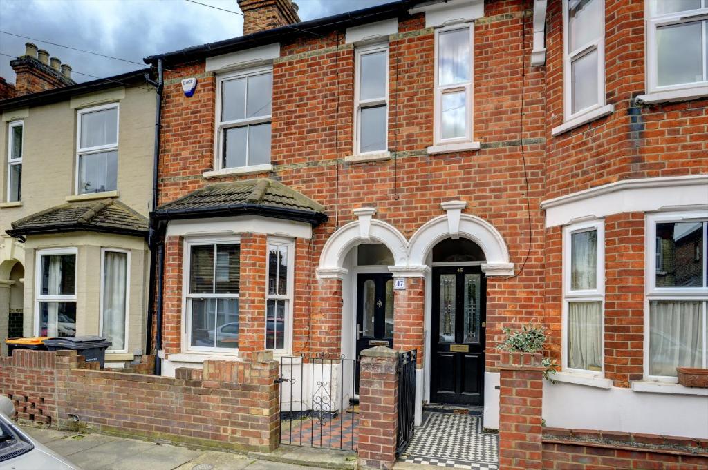 a red brick house with a black door at The Dudley House I Spacious Executive House with Big Kitchen, Dining Space and Garden in Castle Quarter I eco-Short Term Let by SILVA in Bedford