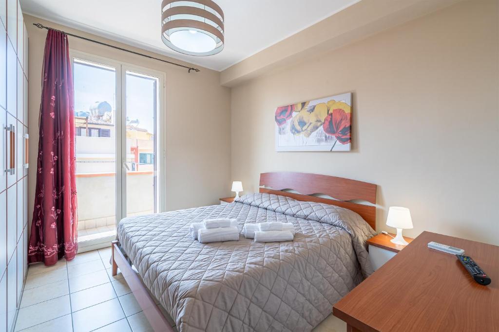 - une chambre avec un lit, une table et une fenêtre dans l'établissement Appartamento Giliberto Luna, à Portopalo di Capo Passero
