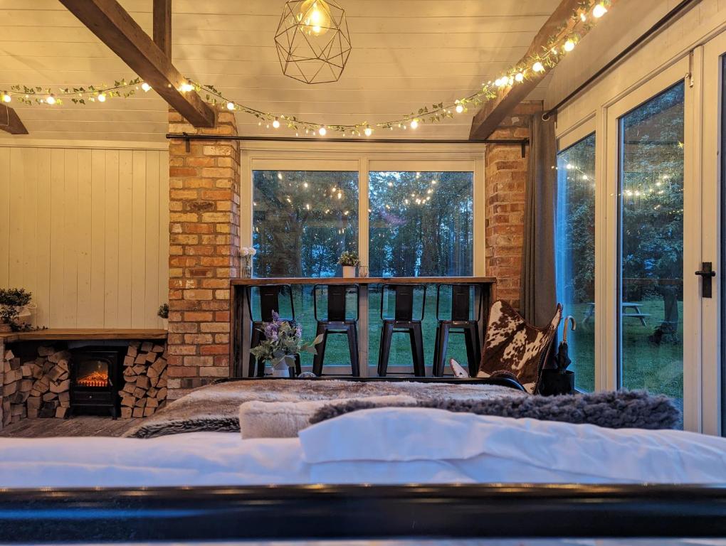 a room with a bed and a fireplace with lights at The Old Forge in Bishop Wilton