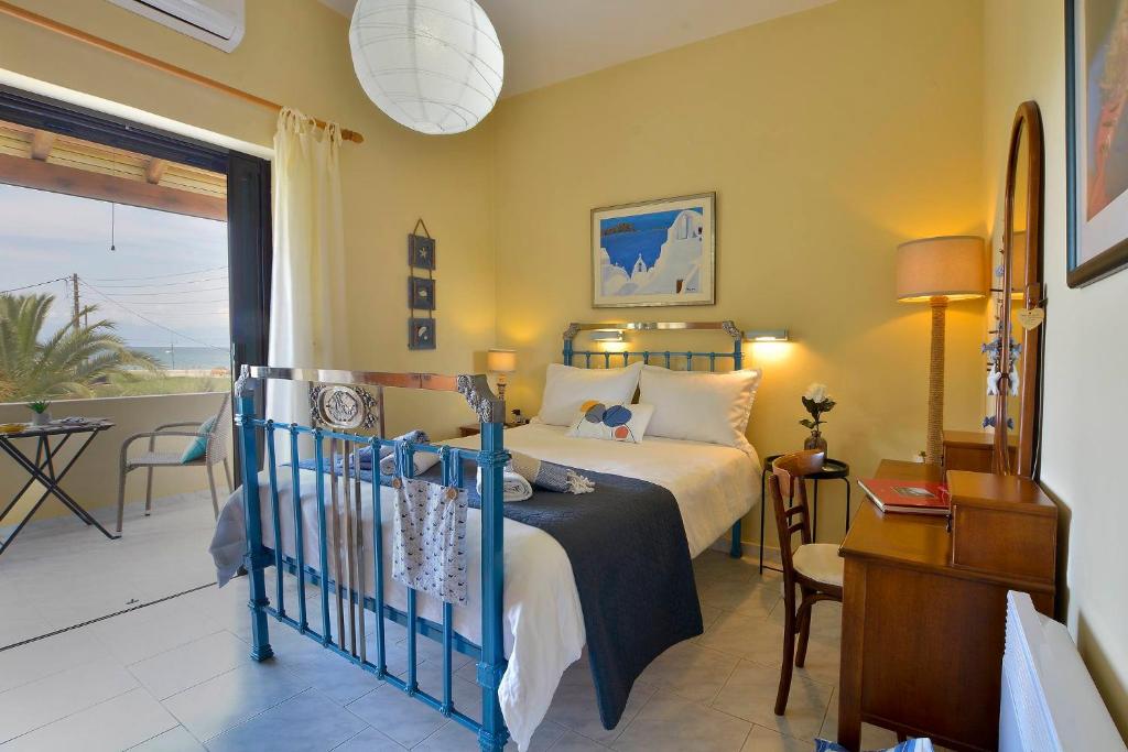 a bedroom with a bed and a balcony at Eleonora Sidari Beach House in Sidari