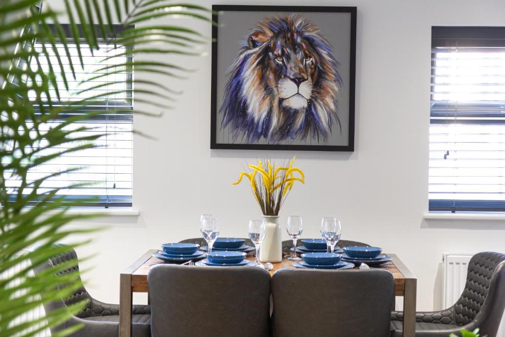 a dining room table with a painting of a lion at At the level - (2 bed flat) in Brighton & Hove