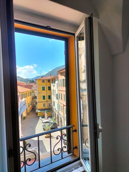 a window with a view of a city street at Casa Monique in Badalucco
